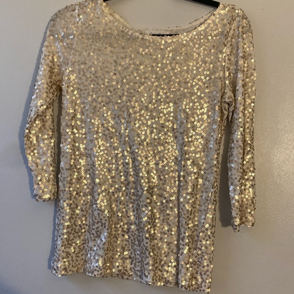 Calvin Klein size extra small long sleeve top with gold sequence.